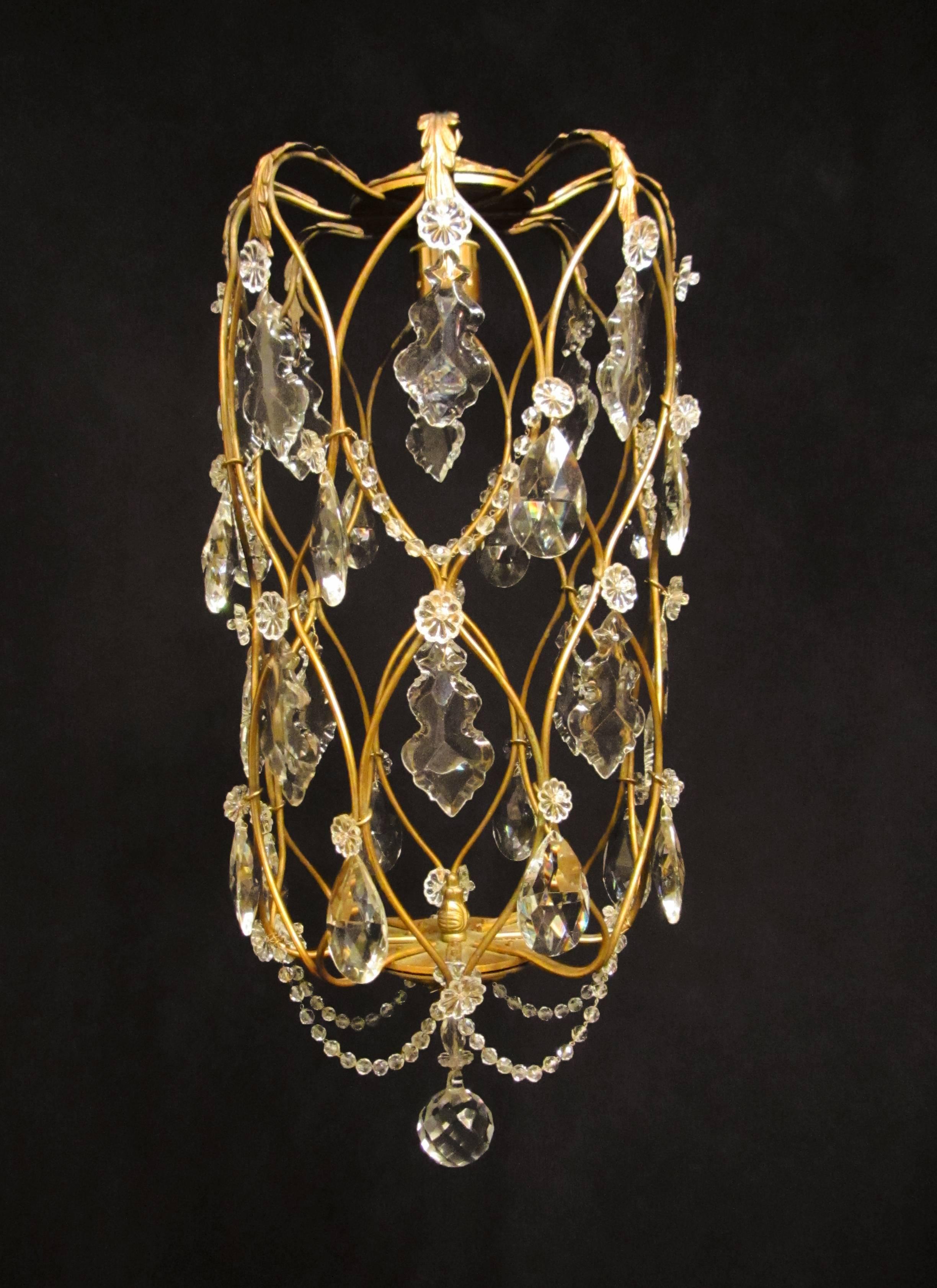 A charming gilt brass cage light, adorned with pretty cut glass plaques, rosettes and beads. 