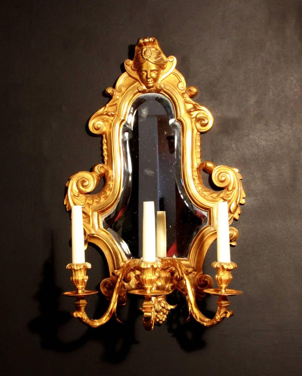 A Louis XVI style, carved giltwood three arm mirrored girandole. 
Professionally wired with French candles, E10.
