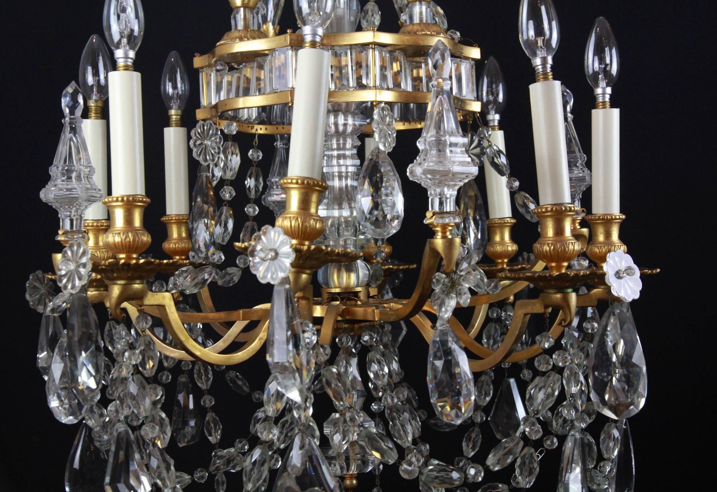 A superb eight-light Bagues ormolu chandelier with cut and faceted plaques and the central stem of very high quality crystal glass. The upper section with diamond cut plaques below large crystal form hearts in the style of Bagues of Paris, all of an