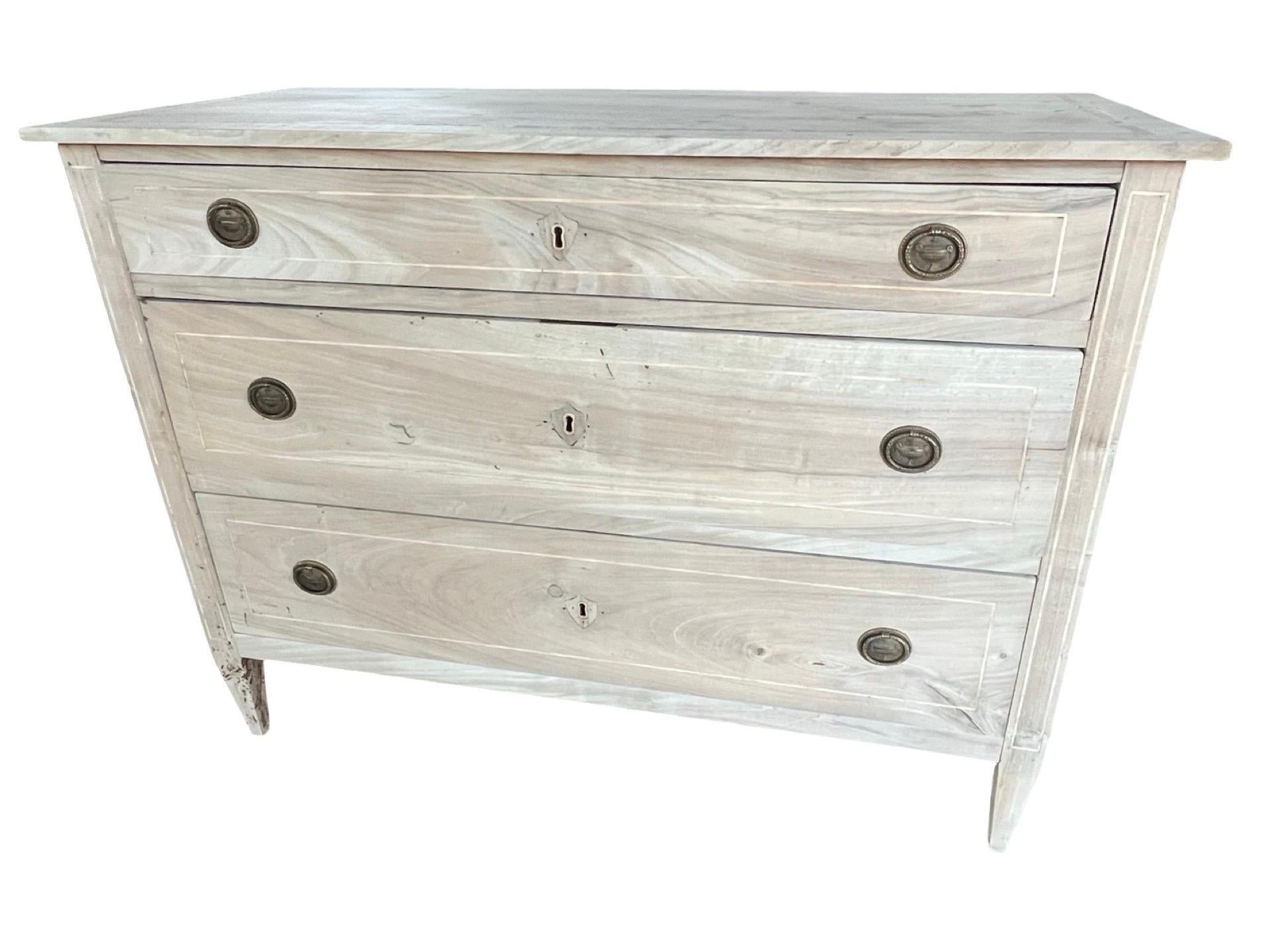 Neoclassical commode hand-made in central Italy in the late 1700s using cherry and decorated with thin satinwood inlaid banding. The commode is rated large in size and features three capacious and functional inset drawers. All drawers show