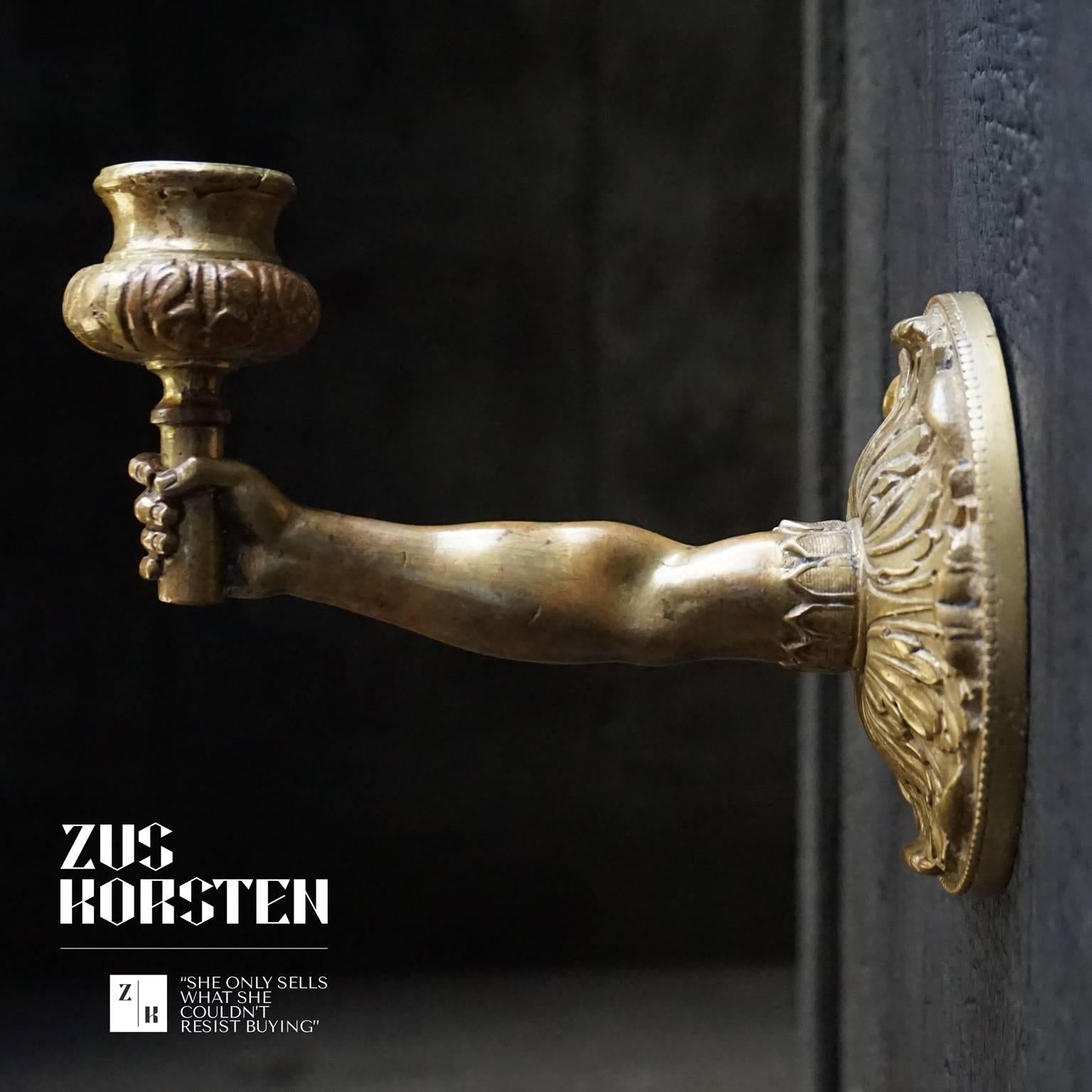 Rare pair of gilt bronze wall sconces. Two, probably French, right hands holding a candleholder, you can take the actual candleholder out of the hands for better candle placing. Arms, hands and central rosettes are beautiful detailed. The hands even