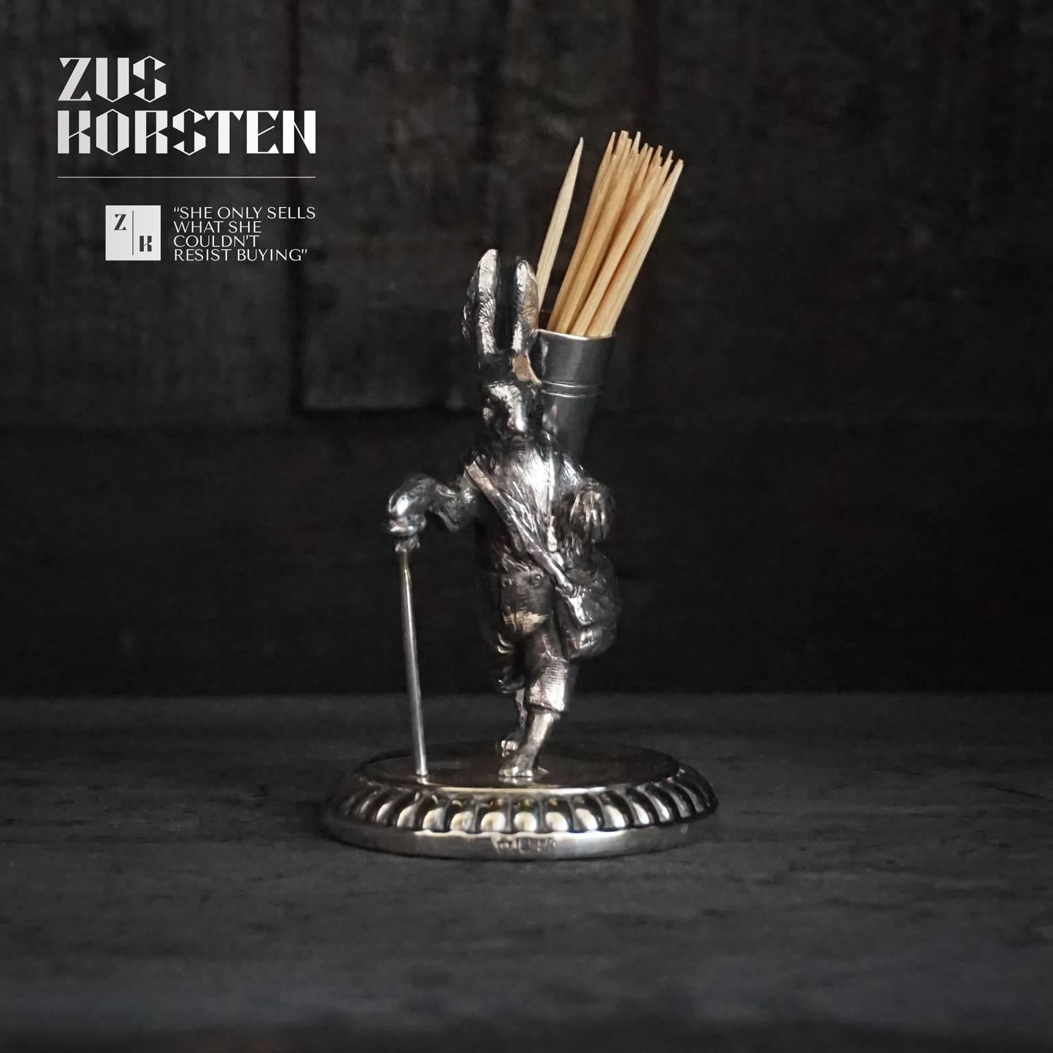 Look at this cute toothpick or cocktail stick holder in the form of a sophisticated rabbit or hare walking with his walking stick. 
It is silver plated and in good condition for its age, take a close look at the pictures there is some plating loss