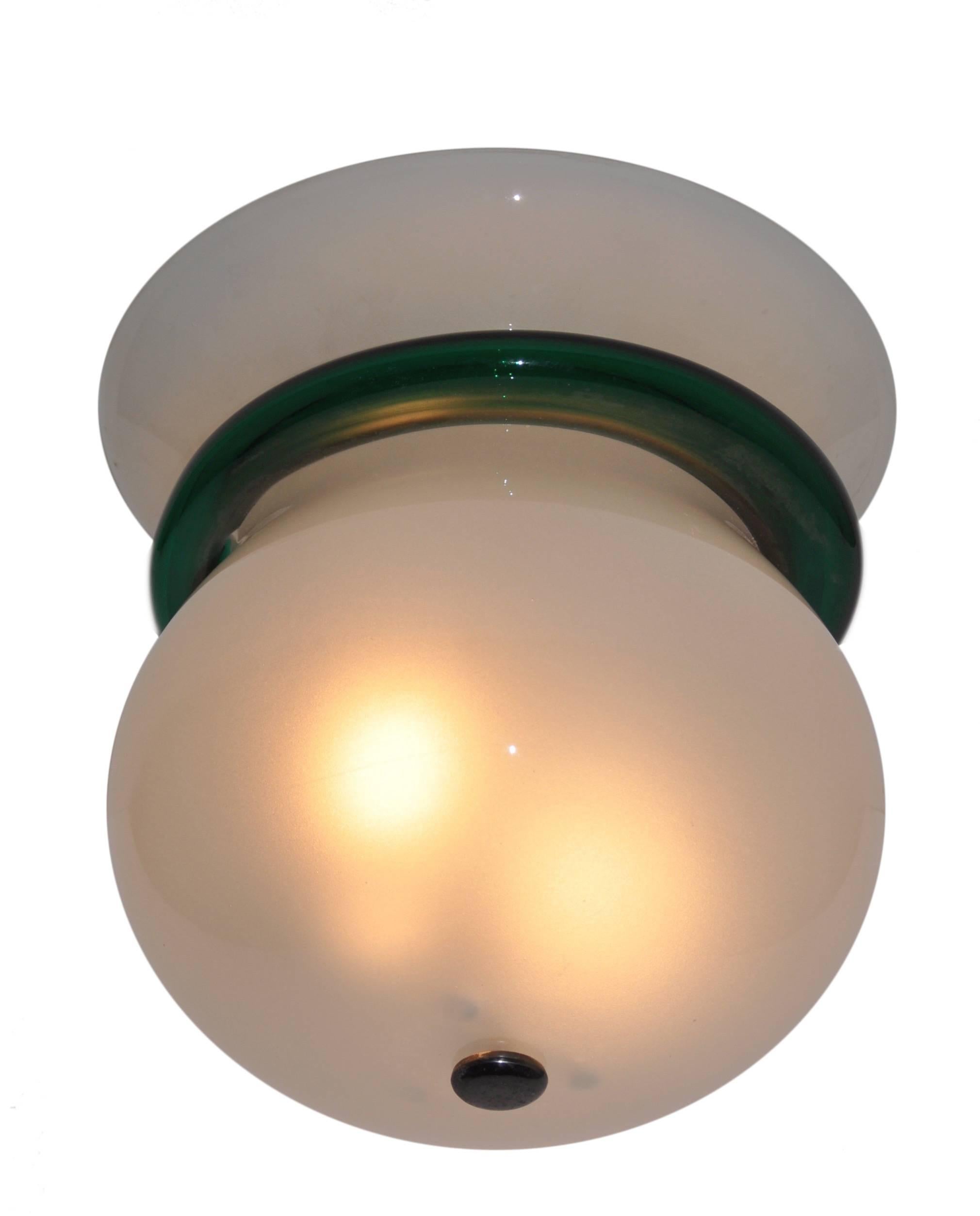 Internally frosted flush mount with a deep green melded band. The flush mount fits two E27 light bulbs. Original hardware.
Excellent condition with good trace of aged.