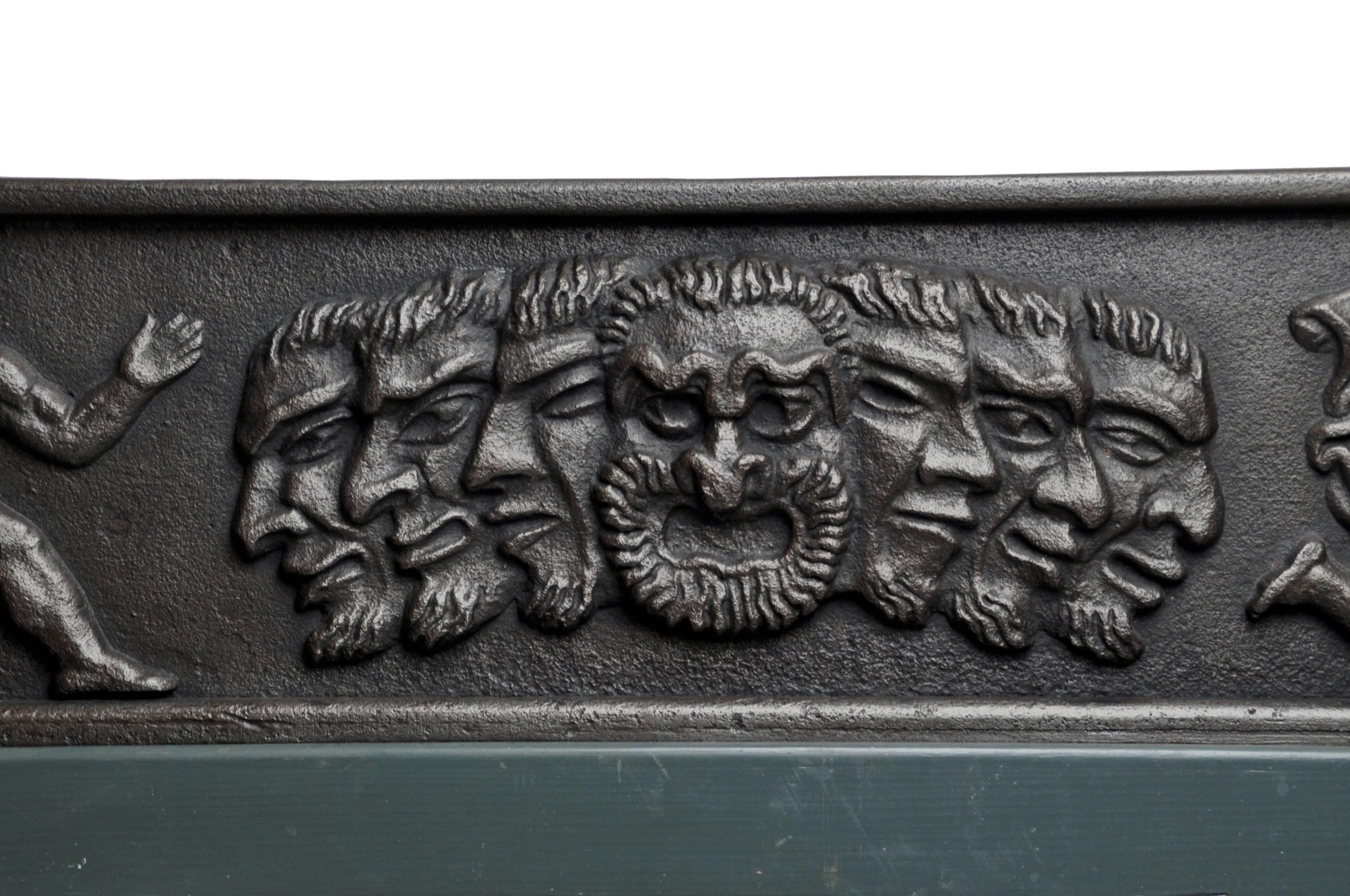 Jardinaire in thick cast iron depicting a classical motif supported by a neoclassical style X frame base with bronze medallions. The underlying wood appears to be painted pine. 
This theatrical motif was first presented on the door lintel of the