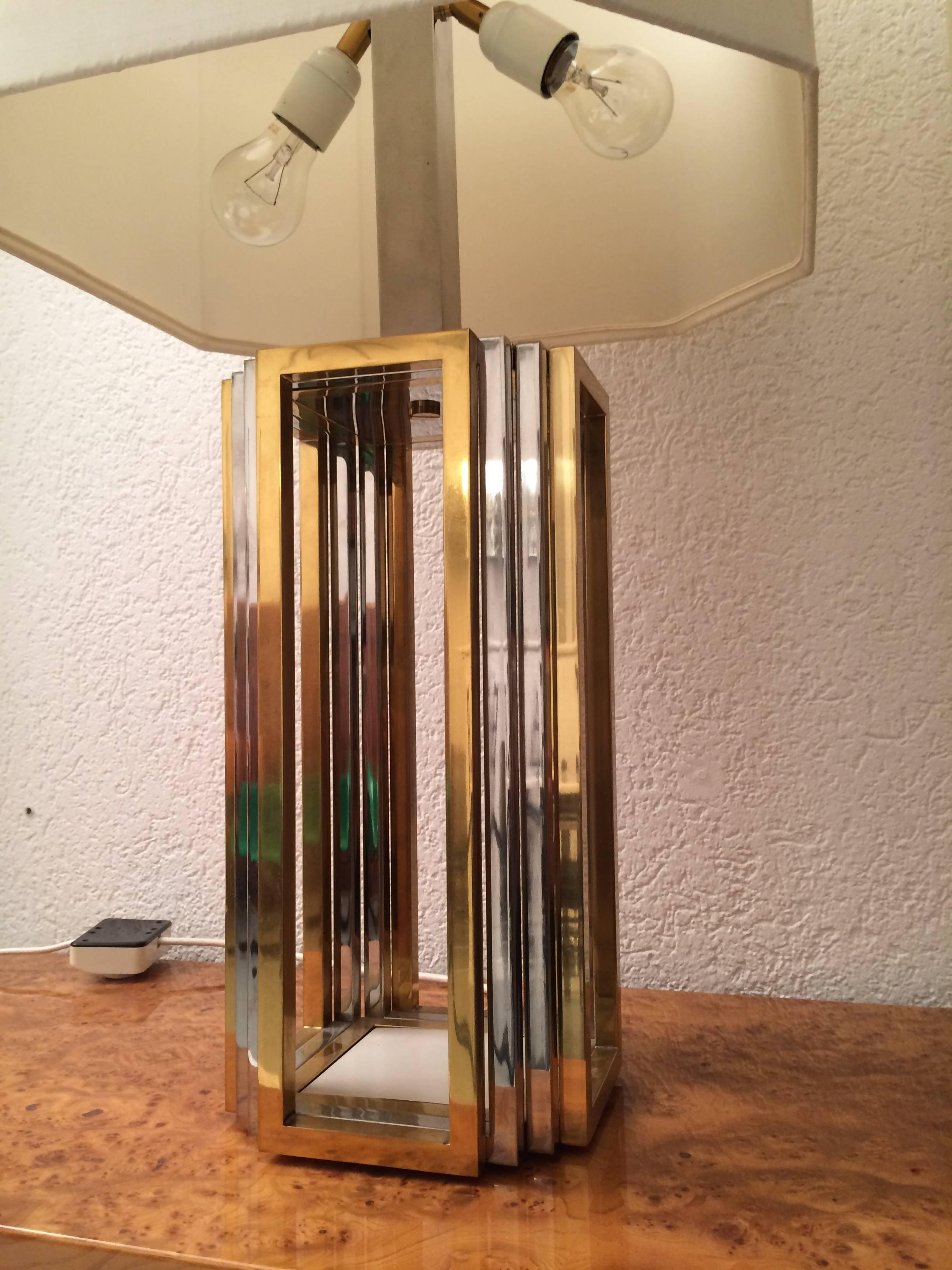 Pair of chrome and brass table lamps, original octogonal silk shades.
three positions of lighting, the two bottom bulbs, the one on top or all together.
Very good condition.