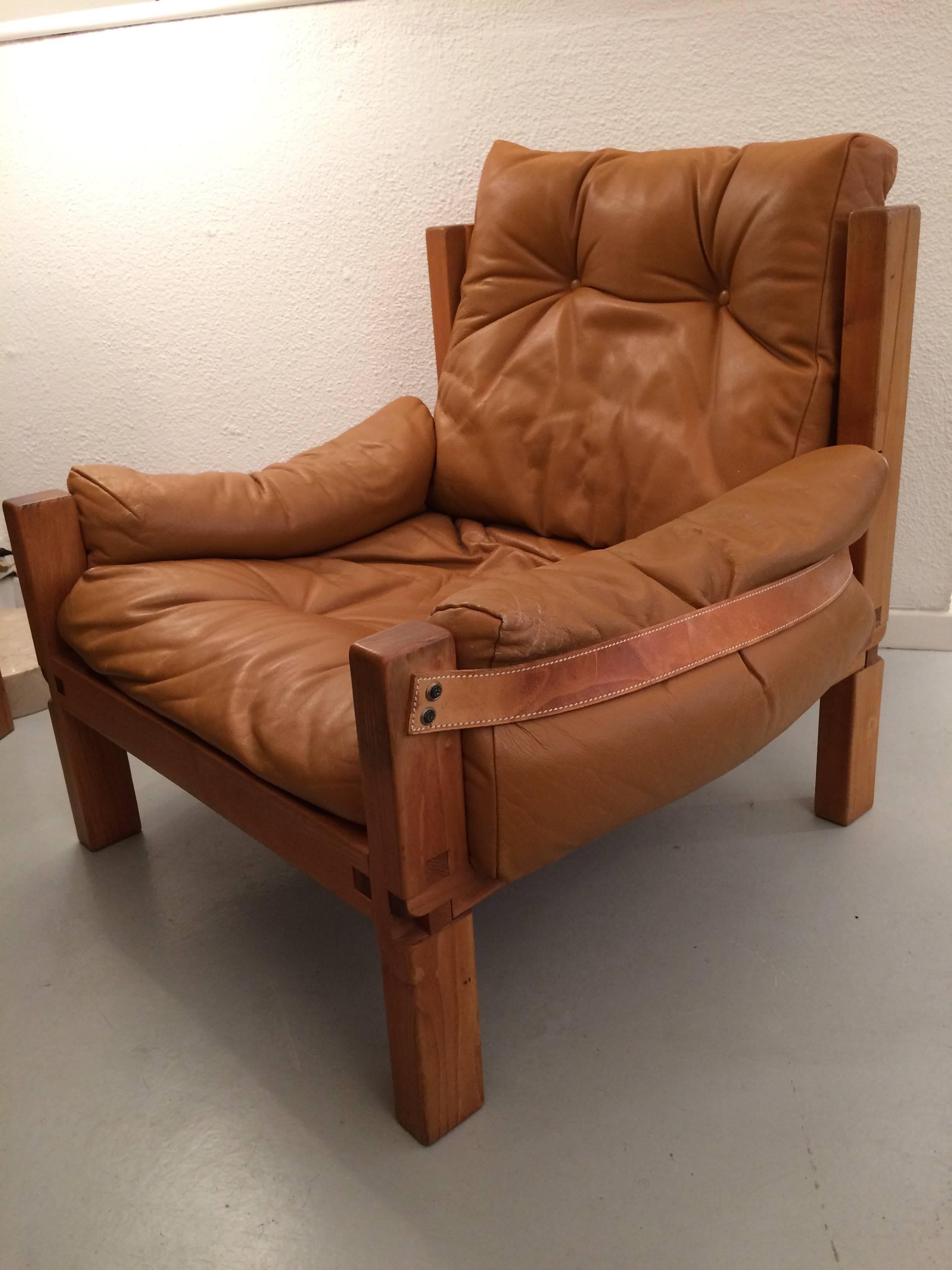 Vintage solid elm and cognac leather armchair by Pierre Chapo.