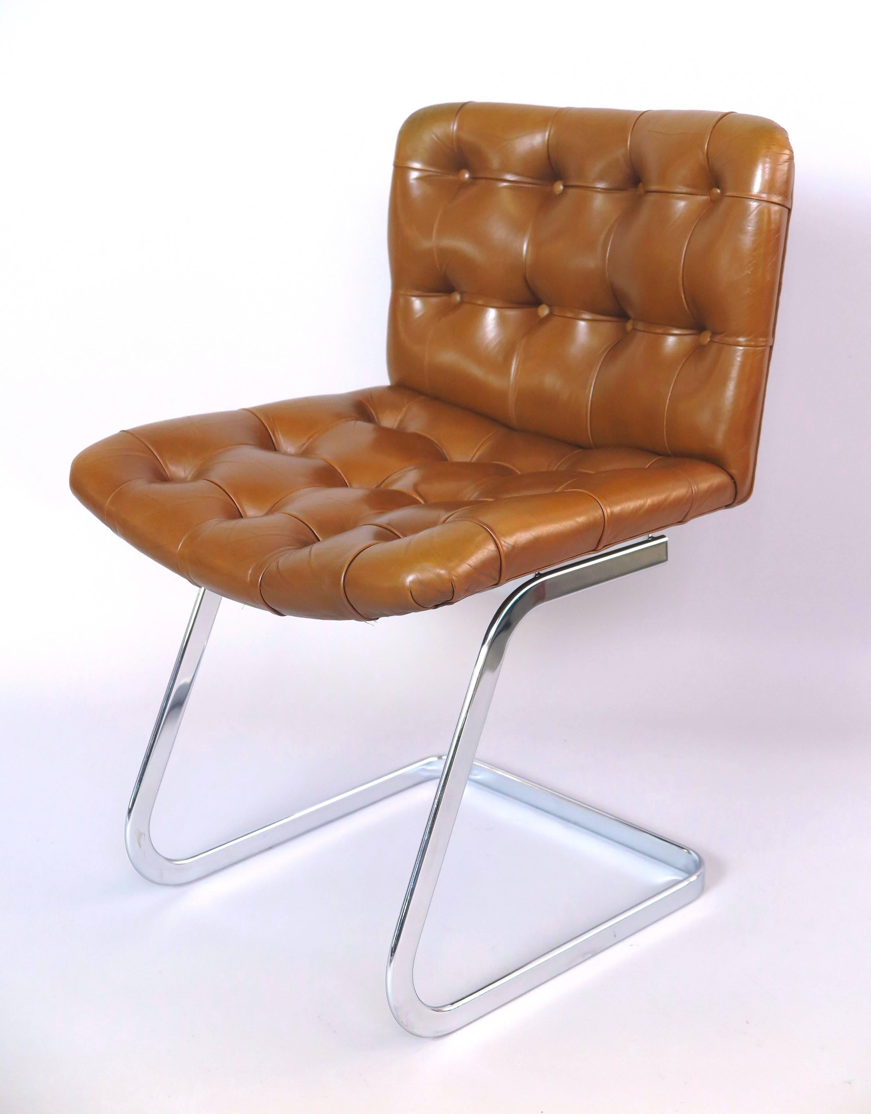 Early edition of the high quality and very comfortable Cantilever chair, designed in 1958 by Robert Haussmann for the UNESCO building in Paris, Button-tufted leather, chrome.
 