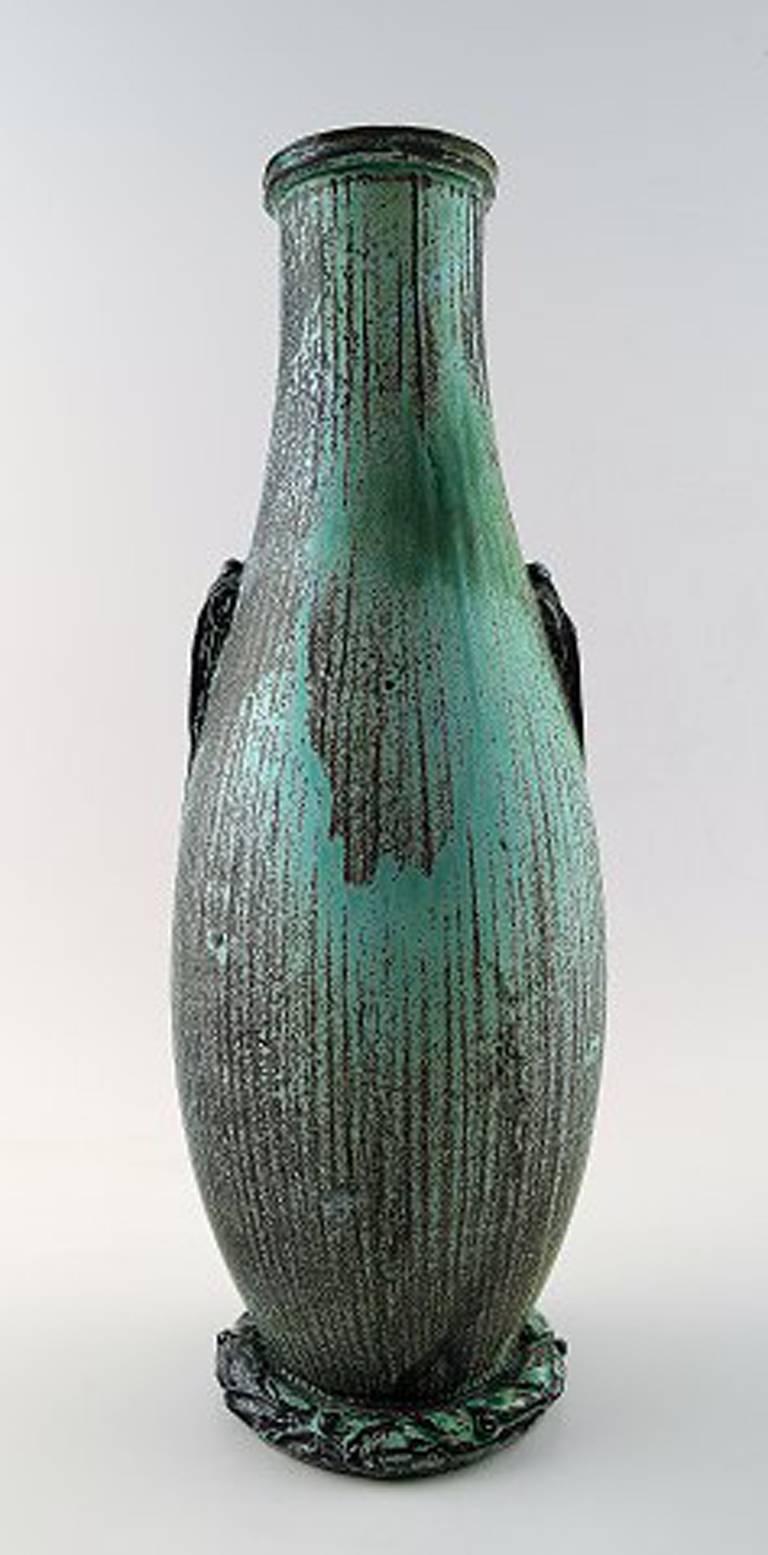 Svend Hammershøi a tall earthenware vase modelled with two small stylized handles. 

Decorated with green and black double glaze.

Signed monogram for Svend Hammershøi and HAK. 
Made by Kähler. 

Height 35 cm.

In perfect condition.