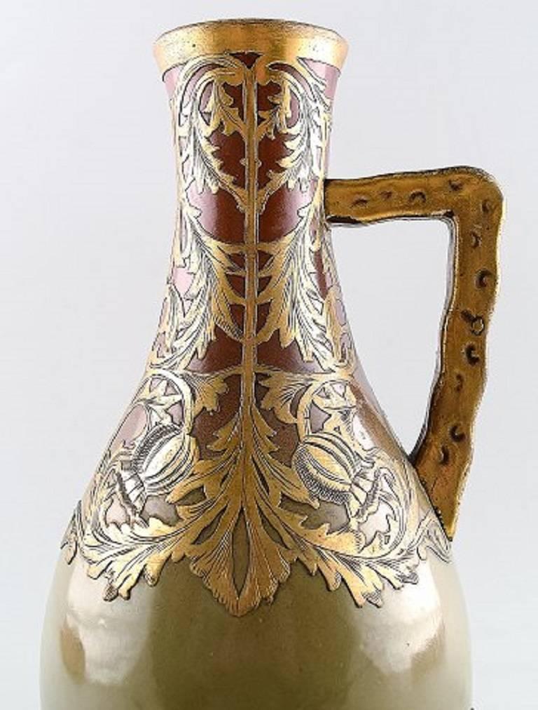French, Sarreguemines Art Nouveau pitcher in ceramics, circa 1910.

Beautiful glaze with gold inlays.

In good condition.

25 cm. high.

Marked.