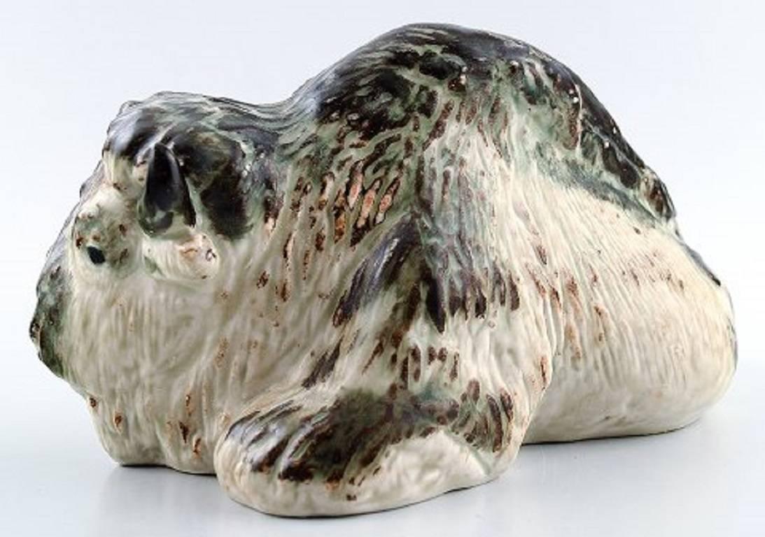 Royal Copenhagen stoneware figurine no. 22604, lying bison.

Measures: 21 x 11 cm.

Designed by Karl Larsen.

In perfect condition, 1st. factory quality.