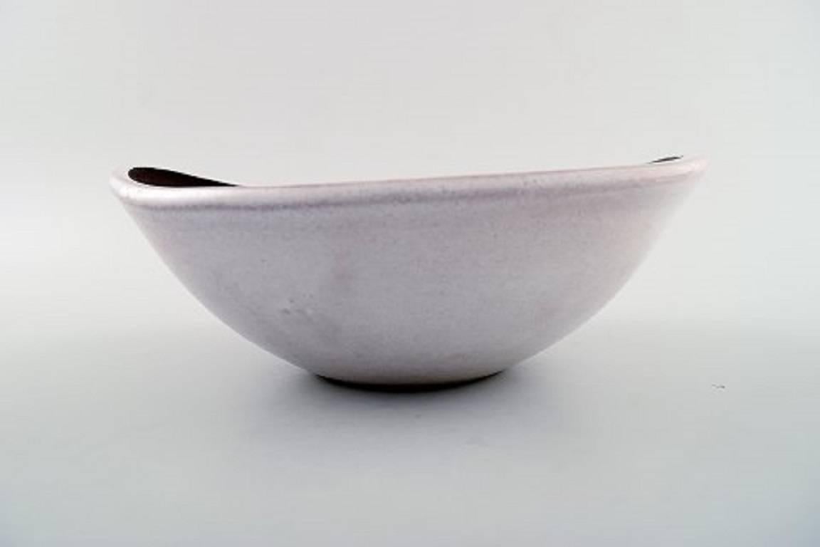 Ingrid Atterberg bowl for Upsala Ekeby of Sweden.

Produced between 1953-1958, it is from the Negro Series. 

matte brown glazed finish inside with incised cut design in concentric circles highlighted in creamy white glaze. 

This bowl