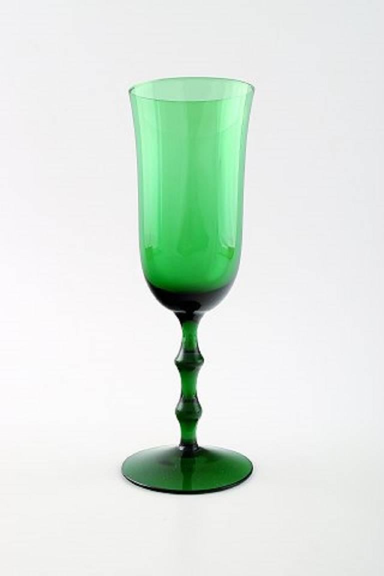 Simon Gate Orrefors, a set of six green champagne art glasses.

Designer: Simon Gate.

Series: Salut.

Producer: Orrefors.

Designed: 1923.

Size: Height 19 cm, diameter 6 cm. 

Quantity: Six.