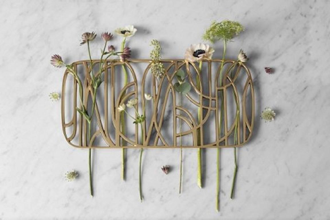 The dew trivet is designed by the Swedish design studio objecthood. 

The trivet is sand cast of solid brass, with a polished surface and a natural, untreated underside. 

Inspired by floral patterns from 20th century Art Deco, a style