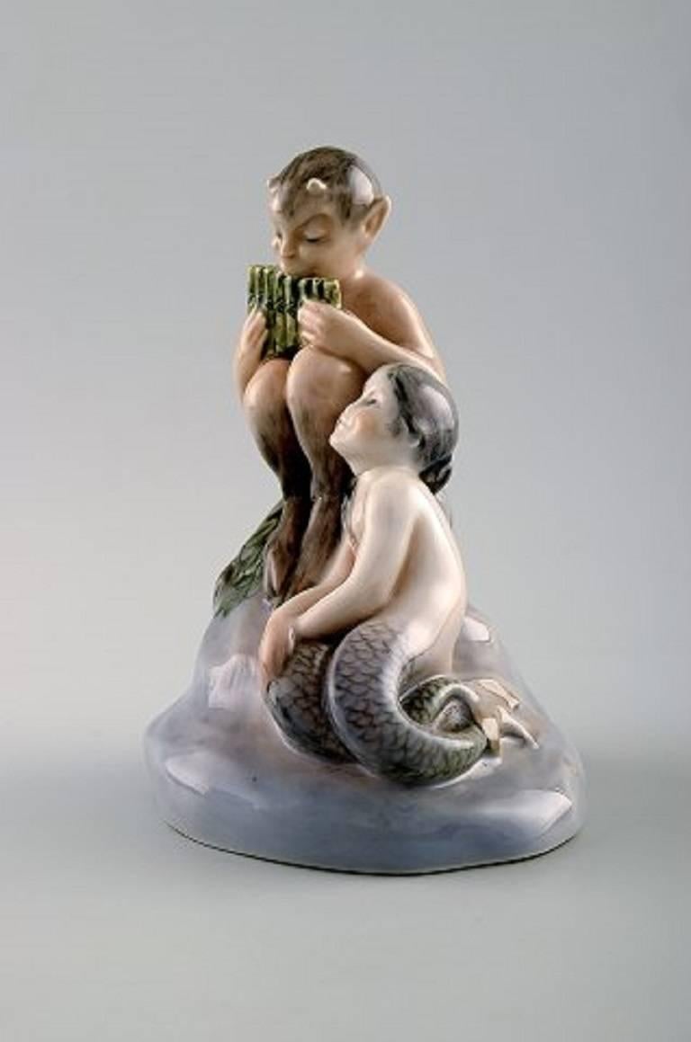 Very rare Royal Copenhagen 2299 Faun satyr with Mermaid girl.

Measures: 14, 5 cm. x 12 cm.

VW for V. Waldorff.

Good condition, factory 2nd, burning mark on girls neck.