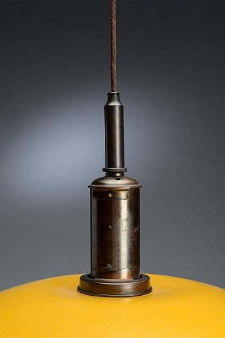 Poul Henningsen. PH 4½-4 pendant lamp with shade yellow painted metal mounted on wire shade holder, marked PH4200, patented. 

Bayonet-shaped socket of copper.

Danish design 1940s.

Measures: Top shade diameter 45 cm. middle shade diameter 26