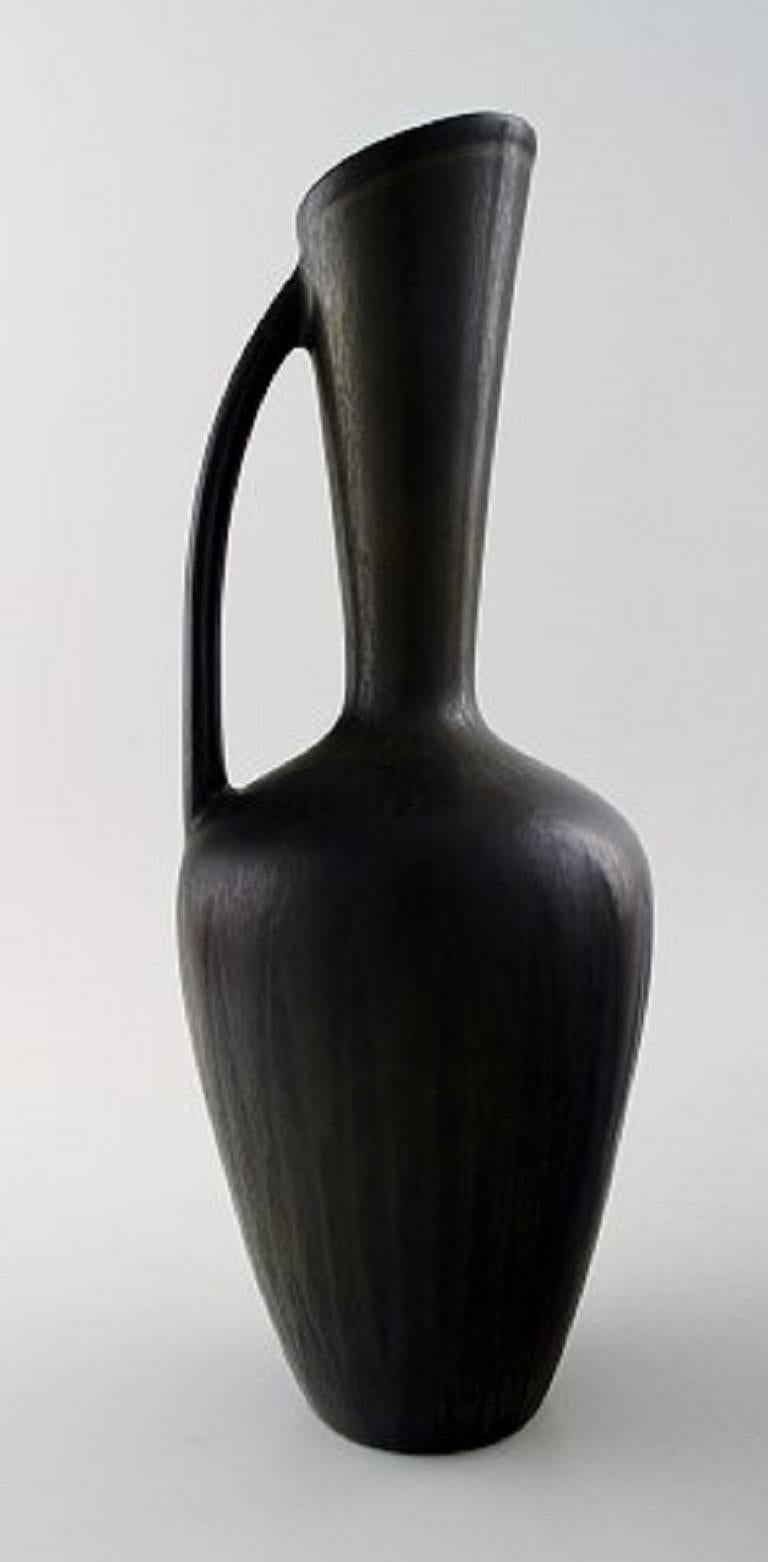 Gunnar Nylund, Rörstrand two vases/pitchers in art pottery.

Beautiful glaze in olive black.

Mid-20th century, Sweden.

In perfect condition.

Measures 36 cm. x 9 cm. and 28 cm. x 10 cm.

Marked.