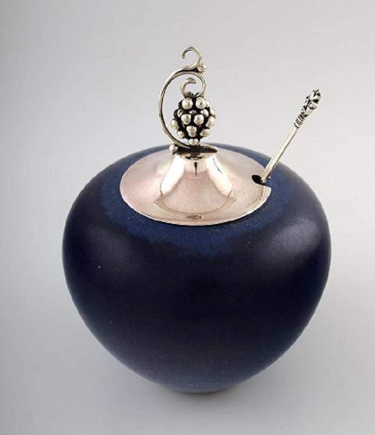 Saxbo and Georg Jensen, large Saxbo ceramic vase with matching lid in sterling silver, Georg Jensen acorn spoon.

Beautiful dark blue glaze. 

All stamped. 

Lid and vase with indistinct marks.

In perfect condition,
