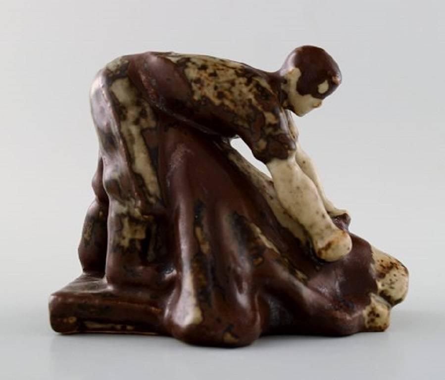 Saxbo, 'Tanner', figure stoneware, created by Hugo Liisberg (1896-1958) in 1949 to Danish Tanners Guild, produced by Saxbo.

The figure comes in two sizes, this figure is 9 cm. high and 12 cm. long.

Available in several copies in Vejen art