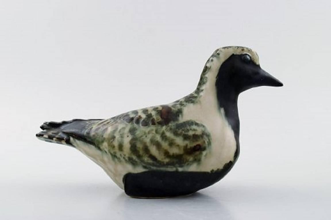 Royal Copenhagen stoneware, number 22486, golden plover. 

Jeanne Grut.

Measures: 10 x 18 cm.

In perfect condition. 1st. factory quality.