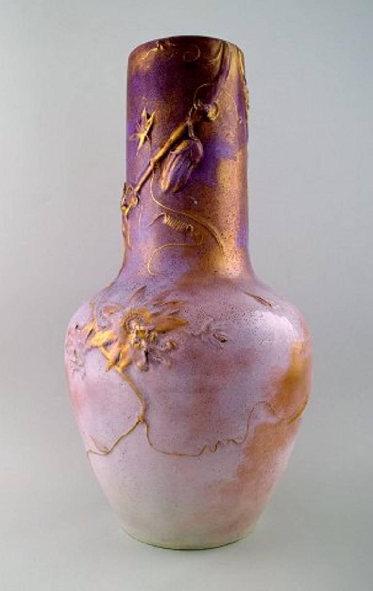 Clément massier for Juan Golf, large French Art Nouveau floor vase in ceramic, decorated with flowers in relief, pink and gold glaze,

early 1900s.

In excellent condition.

Measures: 43 cm high, 22 cm wide.

Stamped.