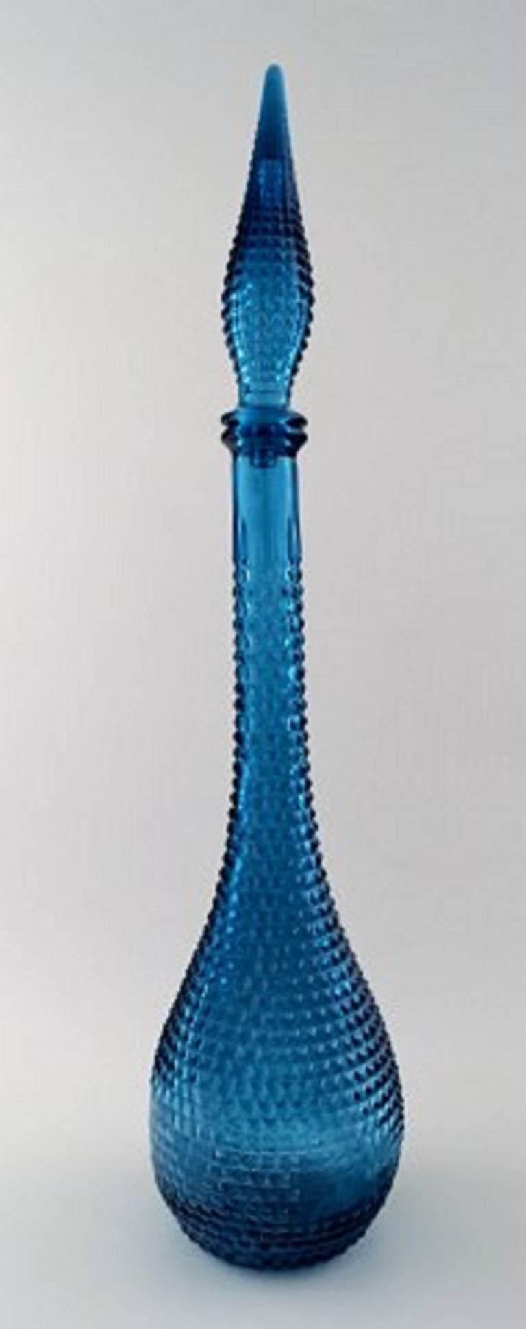 A pair of very tall turquoise decanters. Venini style, 1960s-1970s.

Measures: 56 cm x 13 cm.

In perfect condition.

Stamped. Made in Italy.