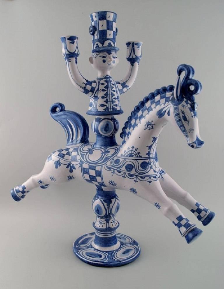 Huge Bjorn Wiinblad figure from the blue house.

Figure or candlestick rider on horseback for three lights.

Decoration number L22.

This is made in 1980.

Measure: Height 62 cm, length 50 cm.

Perfect condition.
