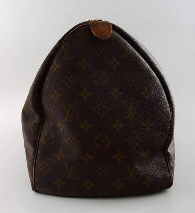 Louis Vuitton: Monogram canvas vintage 1960s bag with two leather straps, handles with durable brass hardware. The top brass zipper opens to a spacious cocoa colored fabric interior. This is an excellent vintage bag for all of your needs for the