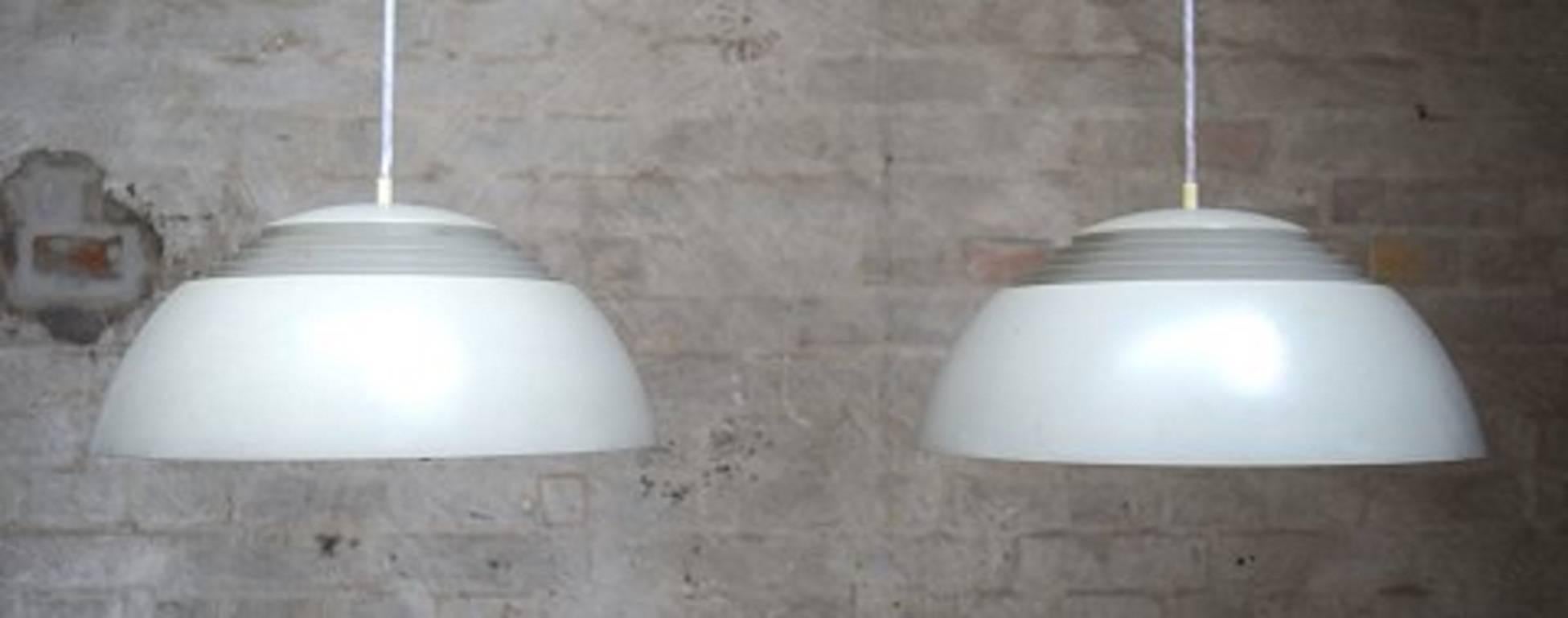 Arne Jacobsen, 1902-1971. A pair of AJ pendants of gray lacquered metal.
Measures: Diameter 50 cm.
Designed in 1958. Produced by Louis Poulsen, Denmark. 
Danish design.
In good condition. Minor age and wear.