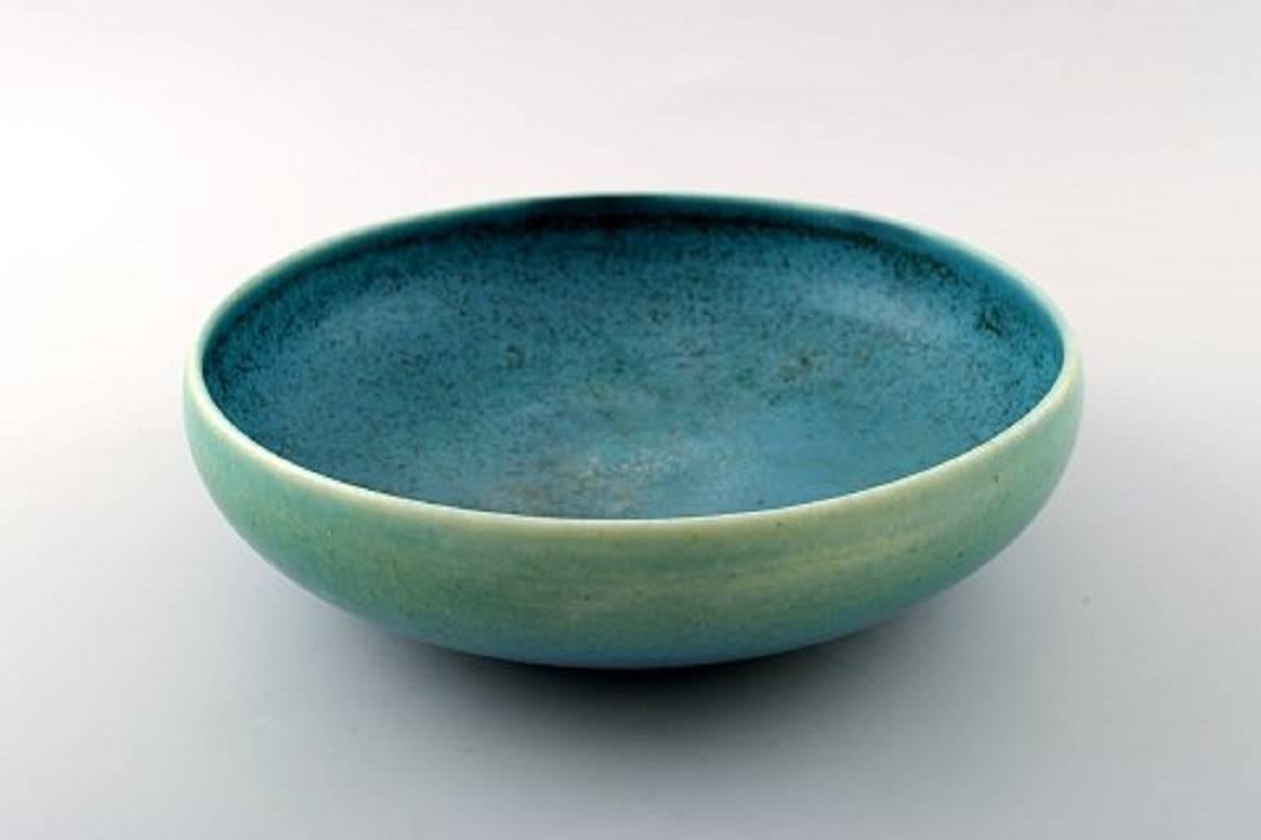 Early Saxbo, ceramic bowl in modern design.
Beautiful glaze in green tones.
Stamped. Model number 57.
Measures: 23 cm x 7 cm.
In perfect condition.