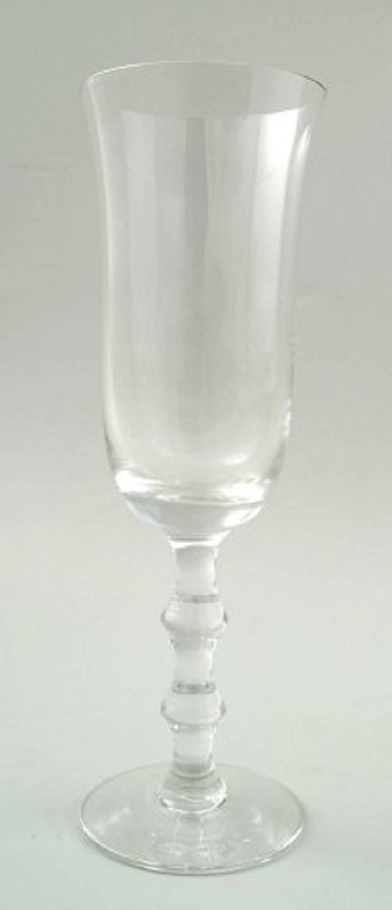 Simon Gate for Orrefors, A set of four champagne art glasses. 
Designer: Simon Gate.
Series: Salut
Producer: Orrefors
Country: Sweden
Designed: 1923
Size: Height 19 cm, diameter 6 cm.
