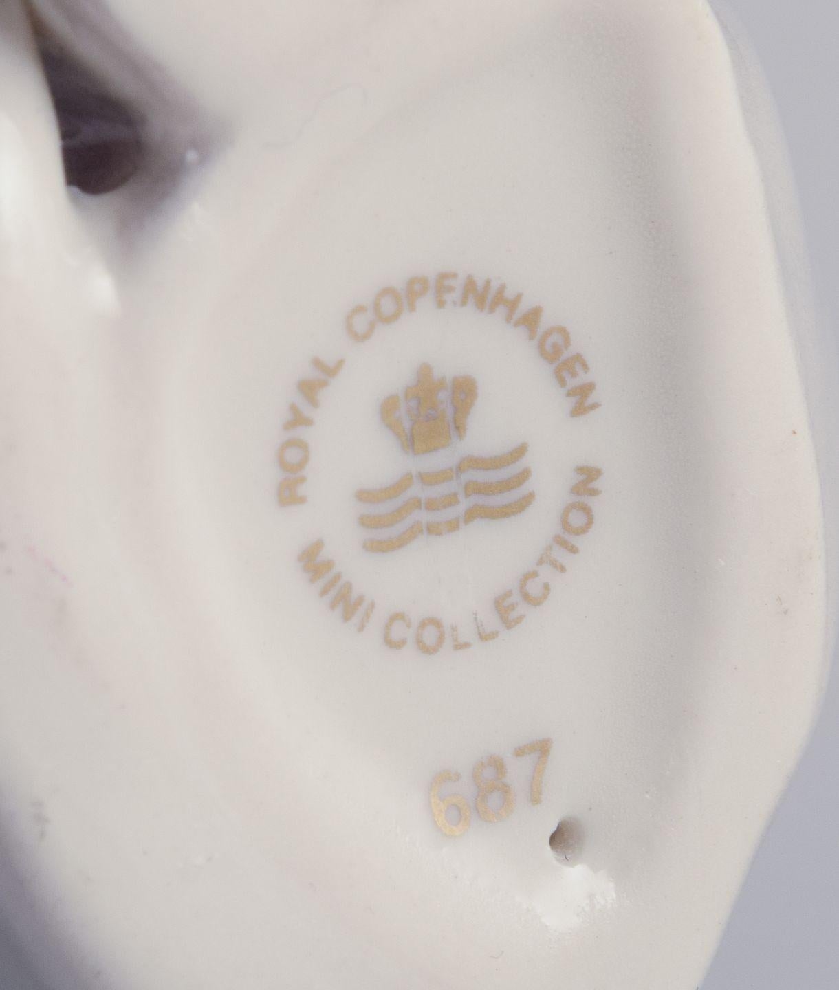 Glazed Royal Copenhagen. Porcelain figurine of a sitting cat. 21st C. For Sale