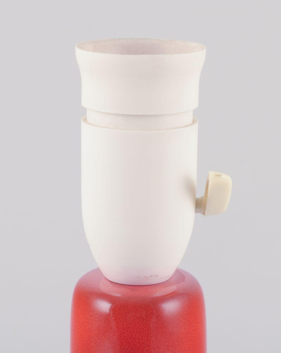 Pre-owned goods are exempt from import duties for U.S. customers. 
Therefore, no import tariffs will be applicable to your purchase.

Frank Keramik, Denmark.
Table lamp made of glazed stoneware.
Minimalist retro design. Hand-glazed with orange
