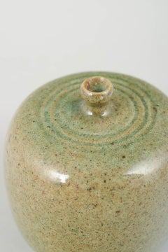 Swedish studio ceramicist. Small stoneware vase with rounded cylindrical form.