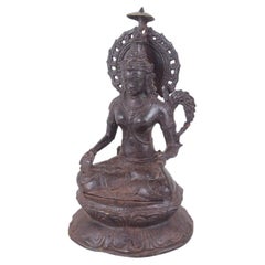 Seated Buddhist figure executed in patinated bronze. Asia, 19th C