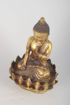 Seated Buddha figure in gilt bronze with one hand raised. Asia, 19th C