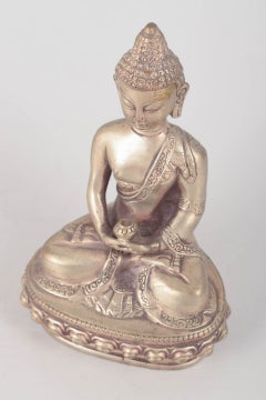 Seated Buddha figure in silver-plated metal. Asia, 19th C.