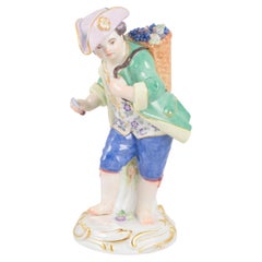 Meissen, Germany. Porcelain figurine of boy with basket of grapes. Early 20th C.
