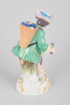 Meissen, Germany. Porcelain figurine of boy with basket of grapes. Early 20th C.