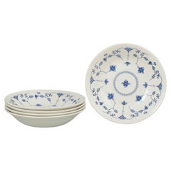 Churchill, Staffordshire. Set of five deep faience plates in blue fluted style.