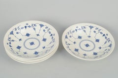 Churchill, Staffordshire. Set of five deep faience plates in blue fluted style.
