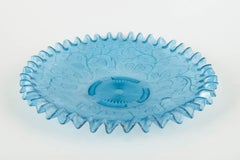 Light blue glass dish with ruffled edge and floral pattern. Early 20th C.