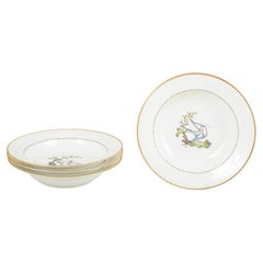 Royal Copenhagen. Set of four large deep plates with bird motifs. Early 20th C.