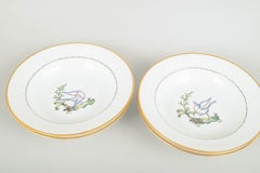 Royal Copenhagen. Set of four large deep plates with bird motifs. Early 20th C.