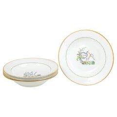 Royal Copenhagen. Set of four large deep plates with bird motifs. Early 20th C.