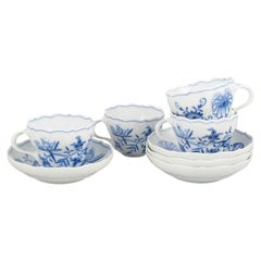 Meissen, Blue Onion. Set of four porcelain coffee cups with saucers. Mid-20th C.