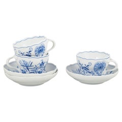 Meissen, Blue Onion. Set of three porcelain coffee cups with saucers. Mid-20th C