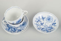 Meissen, Blue Onion. Set of three porcelain coffee cups with saucers. Mid-20th C