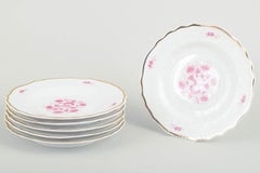 Hollóháza. Set of six porcelain salad plates with pink floral motifs. Mid-20th C