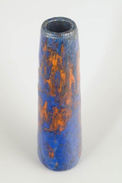 European studio ceramicist. Tall and slender vase in shades of blue and orange.