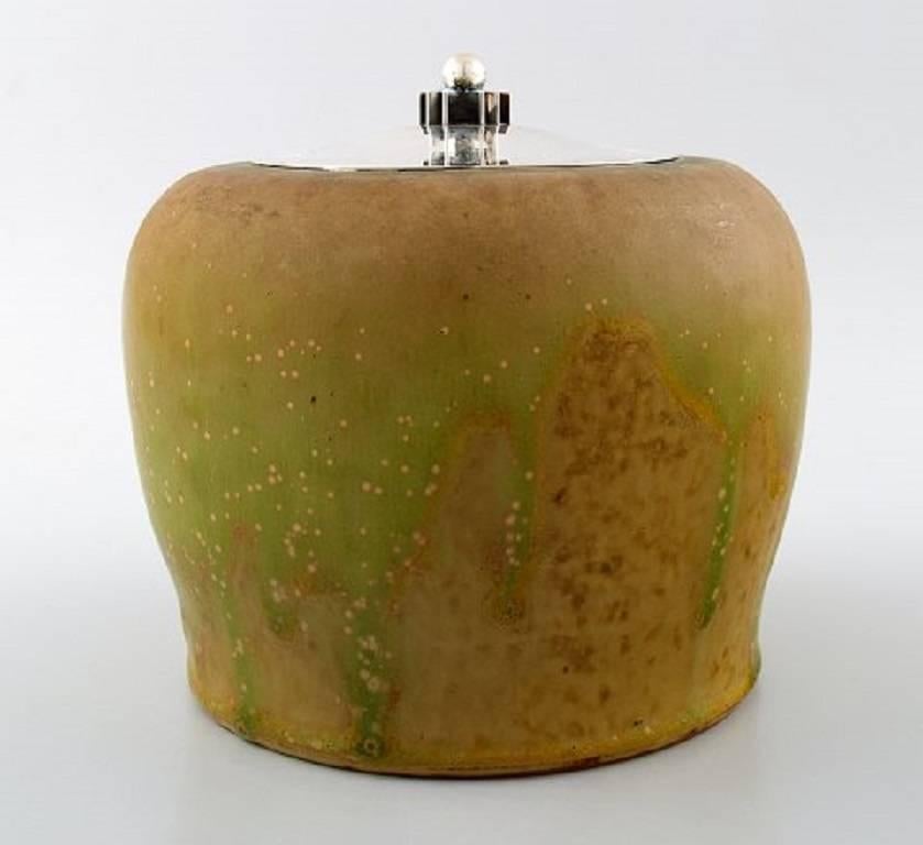 Patrick Nordstrøm for Royal Copenhagen pottery jar with sterling silver lid by Hans Hansen, 1930s.

Beautiful glaze.

In perfect condition.

1st. factory quality.

Measures: 14.5 cm. x 14.5 cm.